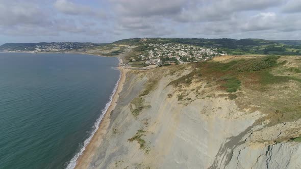 Cliffs on the east side of Charmouth on the Jurassic Coast. Aerial tracking forward over the ancient