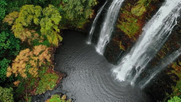 Top-down drone view of a Opaekaa waterfall and autumn forest in Kauai, Hawaii, USA