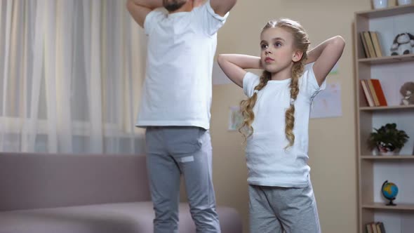 Sport Father With Daughter Doing Squats at Home, Morning Exercises, Discipline