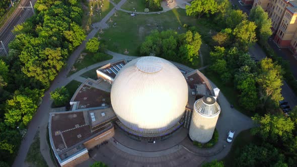 Zeiss Planetarium, elongated park at the S-Bahn tracks.Perfect aerial view flight slowly tilt up dr
