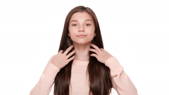 Close Up Portrait of Charming Lady Touching Her Beautiful Very Long Hair Posing on Camera with Smile