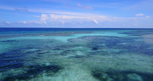 Tropical overhead clean view of a sandy white paradise beach and turquoise sea background in high re