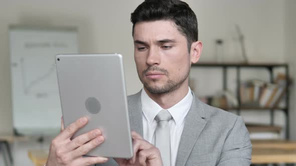 Businessman Browsing and Scrolling on Tablet