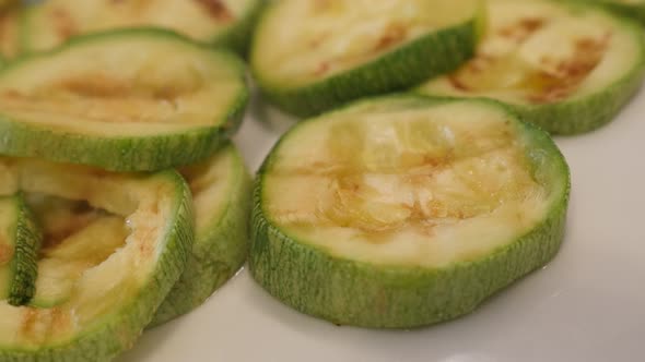 Heat evaporates from grilled zucchini cuts close-up 4K 2160p 30fps UltraHD footage - Hot Pepo cylind