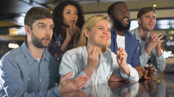 Concentrated Young People Crossing Fingers for Favorite Team Victory Sport Event