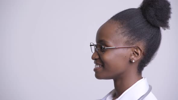 Closeup Profile View of Young Happy African Woman Doctor Smiling