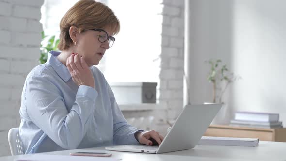 Old Woman with Neck Pain Working on Laptop