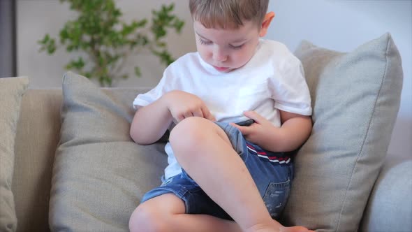 Child Tech Addiction Concept Play Game at Home. Little Boy Preschool Child Using a Digital Tablet