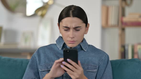 Latin Woman Loss on Smartphone