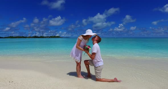 Young lady and man in love dating on vacation spend quality time on beach on summer white sandy back