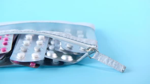 Close Up of Pills of Blister Pack in a Small Bag on Blue Background