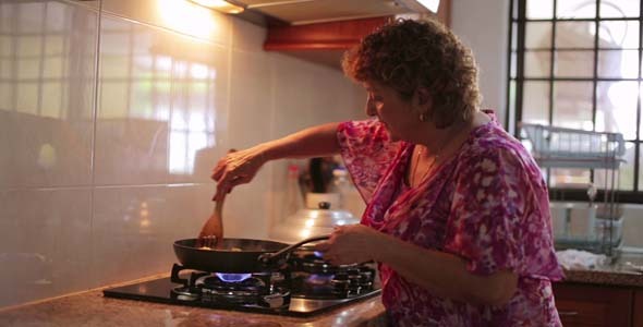 Mother Preparing Food At Kitchen