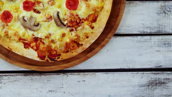 Baked pizza on wooden board