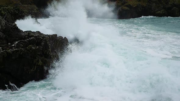 Dramatic Ocean Waves Crashing On Rocks In Slow Motion. Locked Off