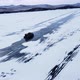 A Hovercraft Rides on the Blue Icy Lake Baikal Covered with White Snow Panoramic Aerial Shot - VideoHive Item for Sale