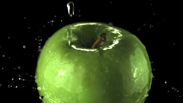 Super Slow Motion Water Droplets Fall on the Rotating Apple