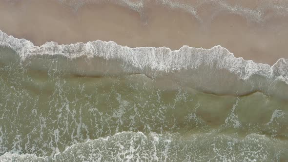 Aerial View of Waves on a Gritty Tropical Beach