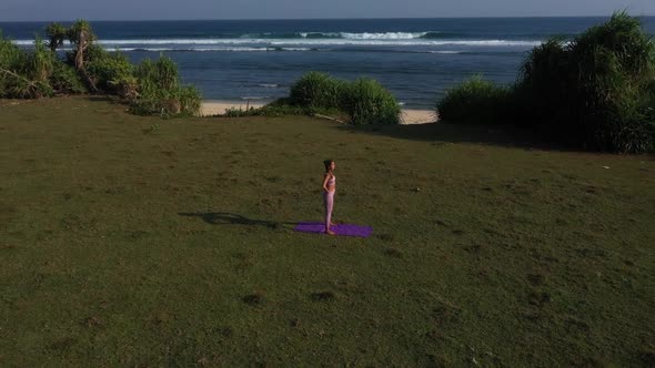 Sporty Woman is Going to Train on Scenic Coast Aerial Landscape