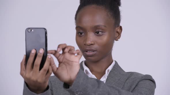 Face of Young Happy African Businesswoman Using Phone