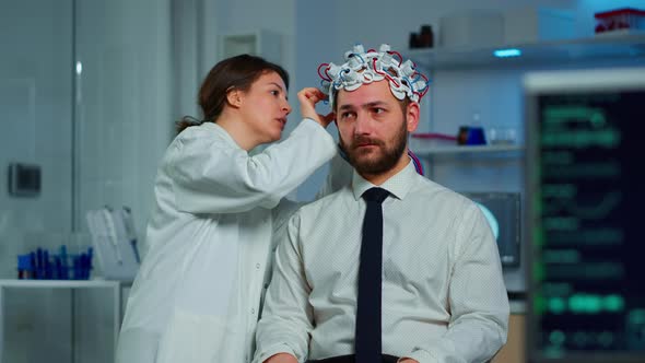 Patient with Brainwave Scanning Headset Sitting in Brain Study Lab