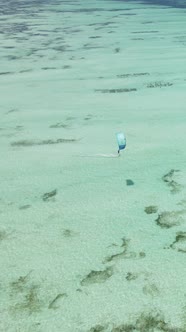 Vertical Video Kitesurfing Near the Shore of Zanzibar Tanzania