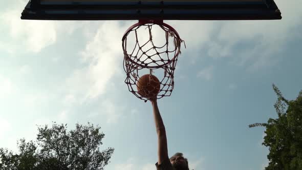 Amateur Caucasian Basketball Player Throw Ball Hight Hit Basket Target in Slow Motion in Front of