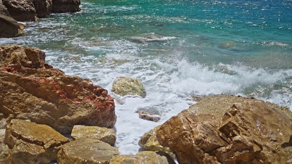 Slow Motion Footage Tropical Island and Sea Waves Crashing and Foaming Against Rocky Beach