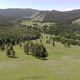 Green Meadows in The Sparsely Wooded Between Forest Covered Hills with Aerial View - VideoHive Item for Sale