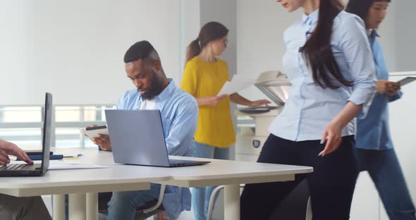 Group of Young Diverse Business People Working and Communicating Together in Creative Office