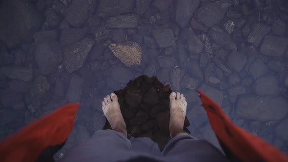 Crop traveler entering shallow clear water