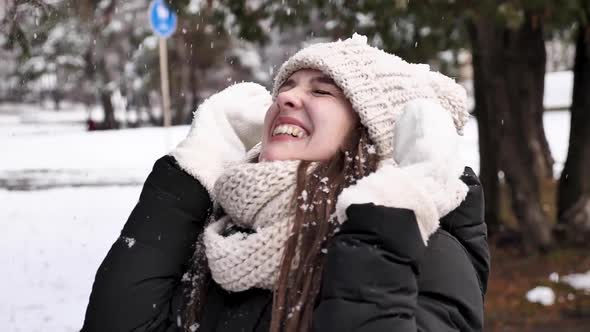 Happy woman enjoying snow in winter