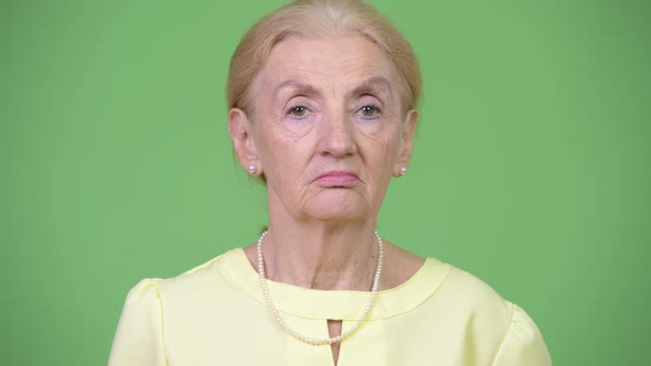 Studio Shot of Beautiful Senior Businesswoman with Blond Hair