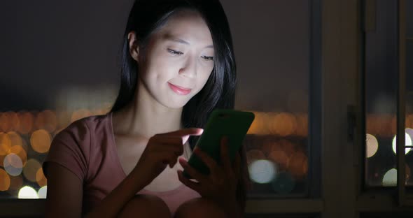 Woman use of mobile phone at night