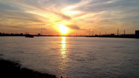 Silhouette cargo ships at the international port of antwerp belgium at sundown