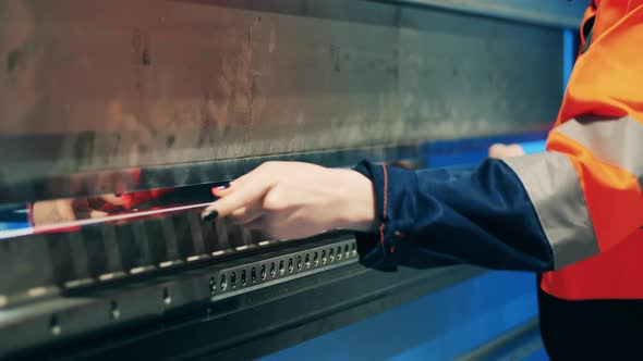 Female Operator is Bending Aluminum with a Factory Machine