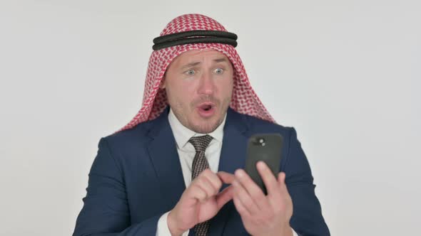 Arab Businessman Reacting to Loss on Smartphone, White Background