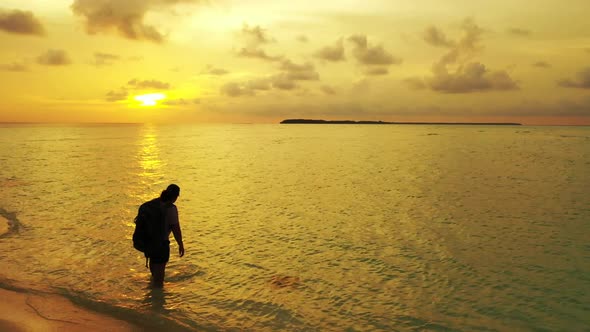 Tourist tans on marine island beach time by shallow sea and white sandy background of the Maldives n