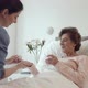 Nurse Administering Medications to Female Senior Patient - VideoHive Item for Sale