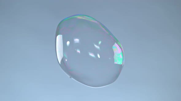 Super Slow Motion Shot of Flying Colorful Soap Bubble on Grey Gradient Background at 1000 Fps