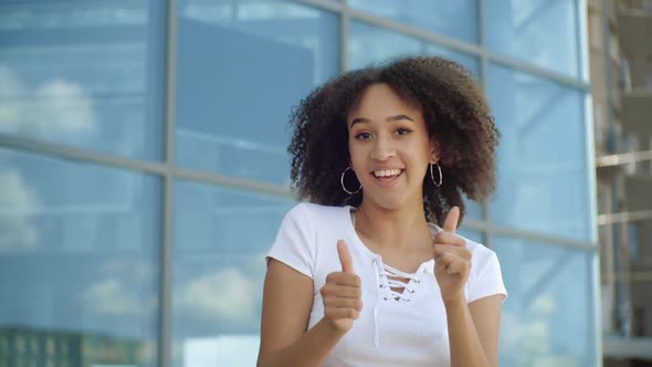 Active African American Ethnic Woman Jumping Dancing Showing Thumbs Up Celebrating Victory with