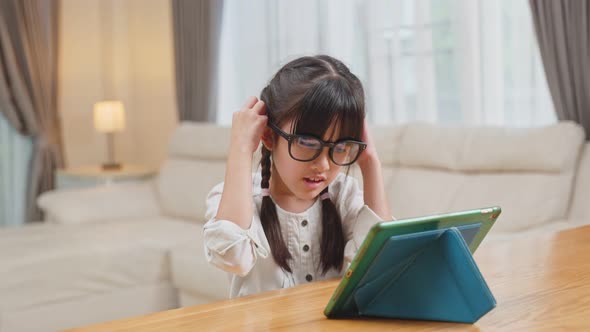 Young small girl student wear eye glasses to protect vision from digital screen for Healthy Eyes.