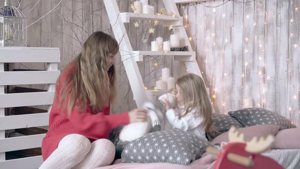 Beautiful Blond Mother Plays with Cute Little Daughter