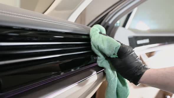 Side View of Man Taking Care of Car Interior in Garage