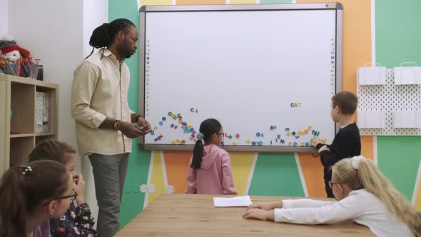 Children Pupils Learn English By Making Words From Letters on a Magnetic Board