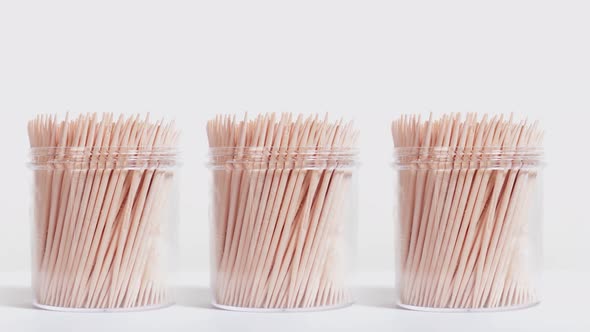 Toothpicks in the Plastic Jars on a White Background