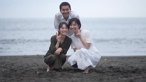 Men and women taking pictures with self-timer