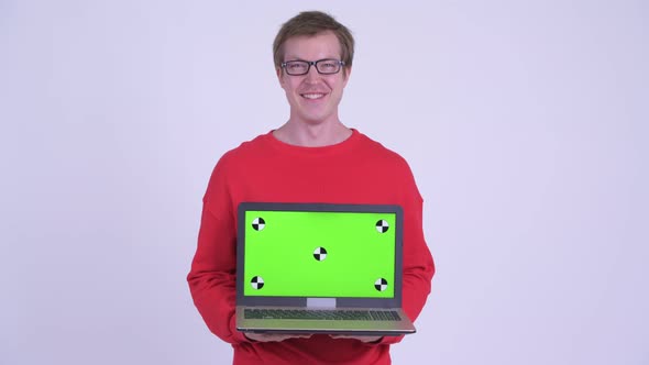 Happy Young Handsome Man Showing Laptop