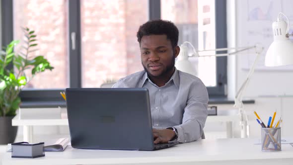 Stressed Businessman with Laptop at Office 