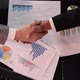 Business Meeting Hand Shake over work and graphics - VideoHive Item for Sale