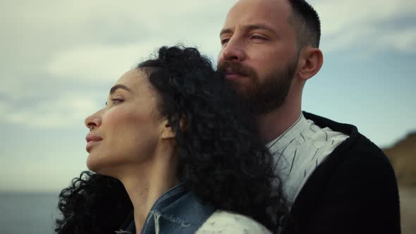 Two People Cuddling Together at Sea Landscape